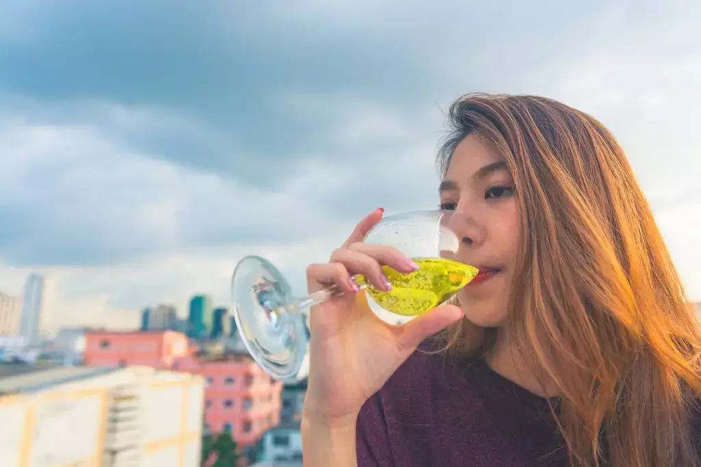 girl drinking beer looking drunk 