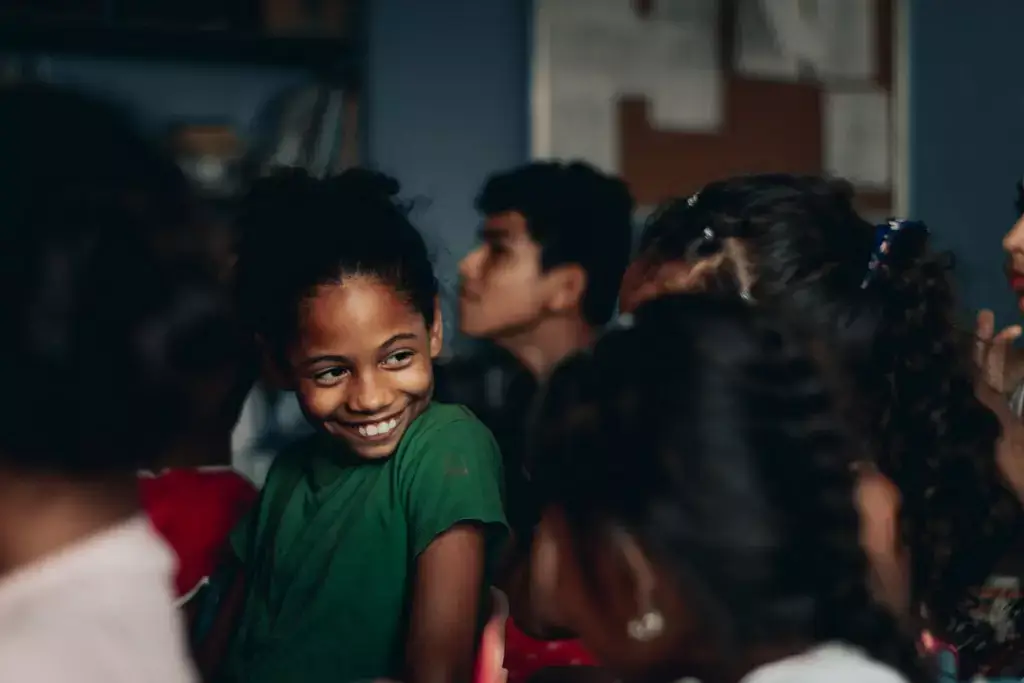 girl smiling at her friends after kissing a guy she's just friends with