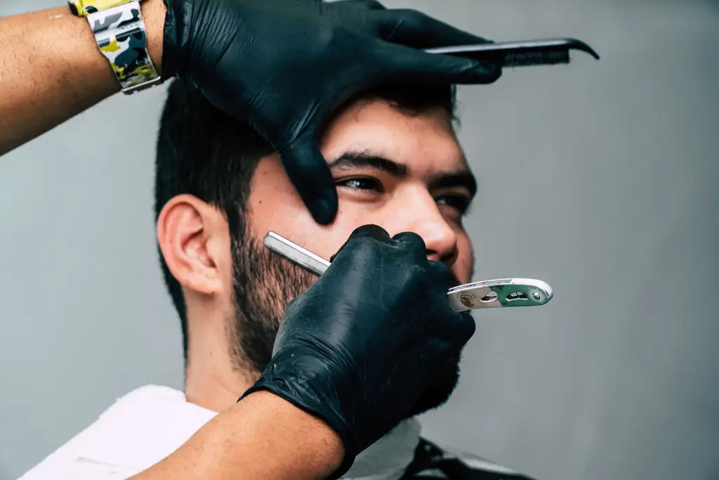 man shaving his beard